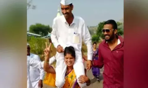 woman carries husband on shoulders