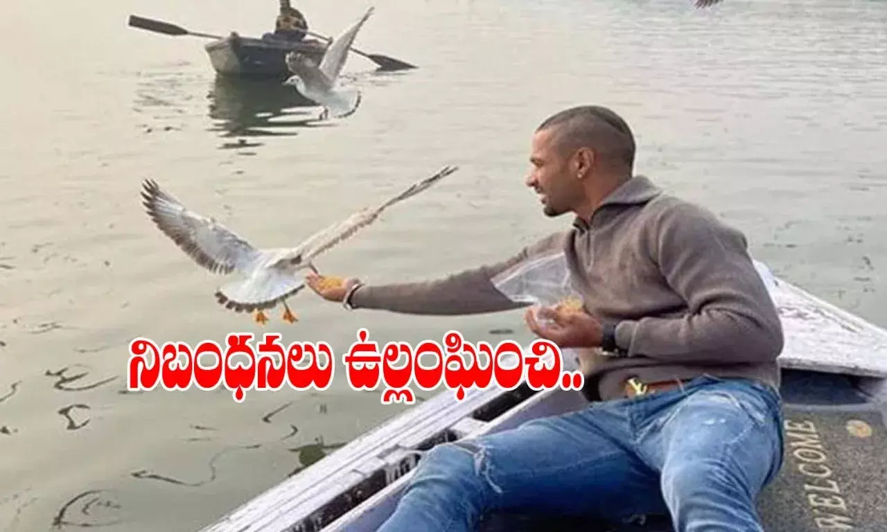 Shikhar Dhawan feeds birds in Varanasi