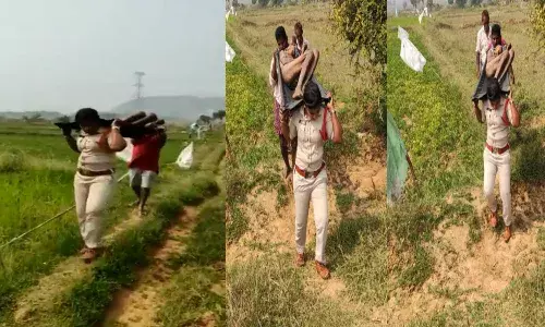 Kasibugga SI Sirisha carries an unidentified man dead body