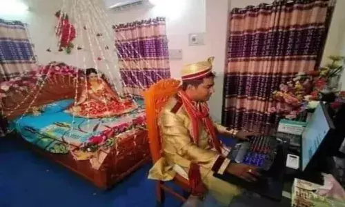 Groom using computer on Wedding night