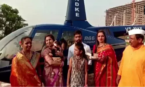 మనవరాలు పుట్టిందన్న సంతోషం.. హెలికాప్టర్లో ఇంటికి తీసుకొచ్చిన తాత..