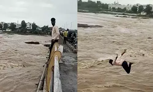 వంతెన పై నుంచి ఉప్పొంగుతున్న నదిలోకి దూకేశాడు.. వీడియో వైరల్