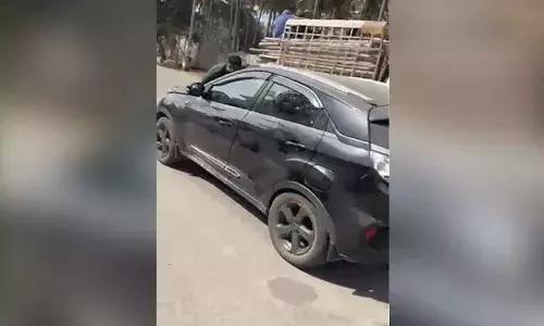 కారు బానెట్పై యువకుడిని ఈడ్చుకెళ్లిన మహిళ