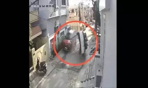 Car flips, hitting parked vehicle,Hyderabad, Neredmet